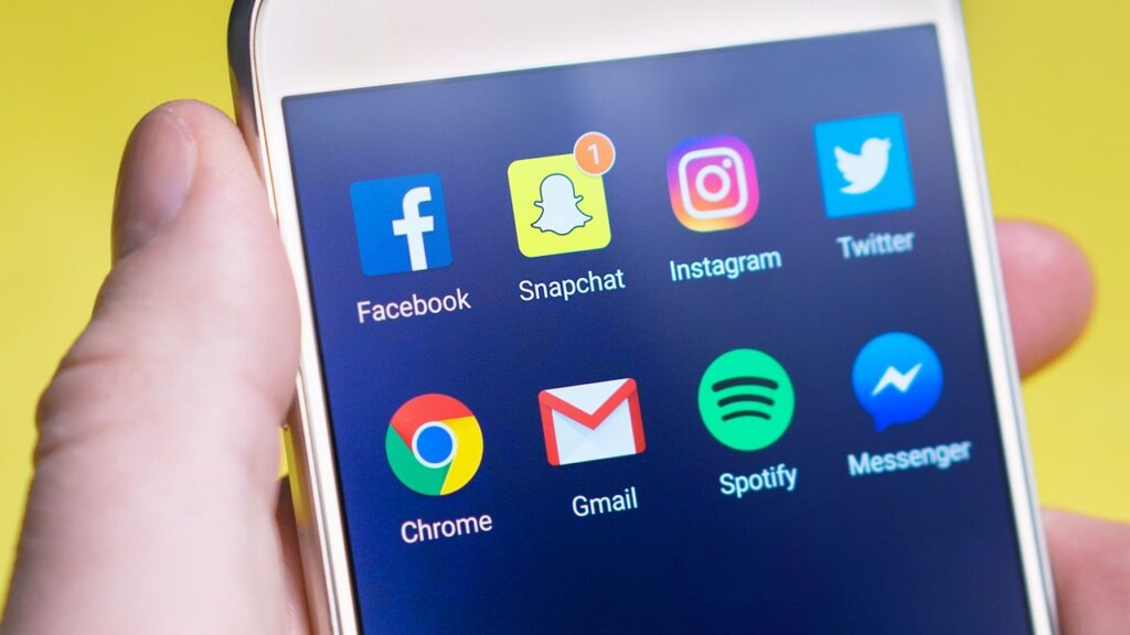 Persona sujetando un móvil Android encendido con dos manos